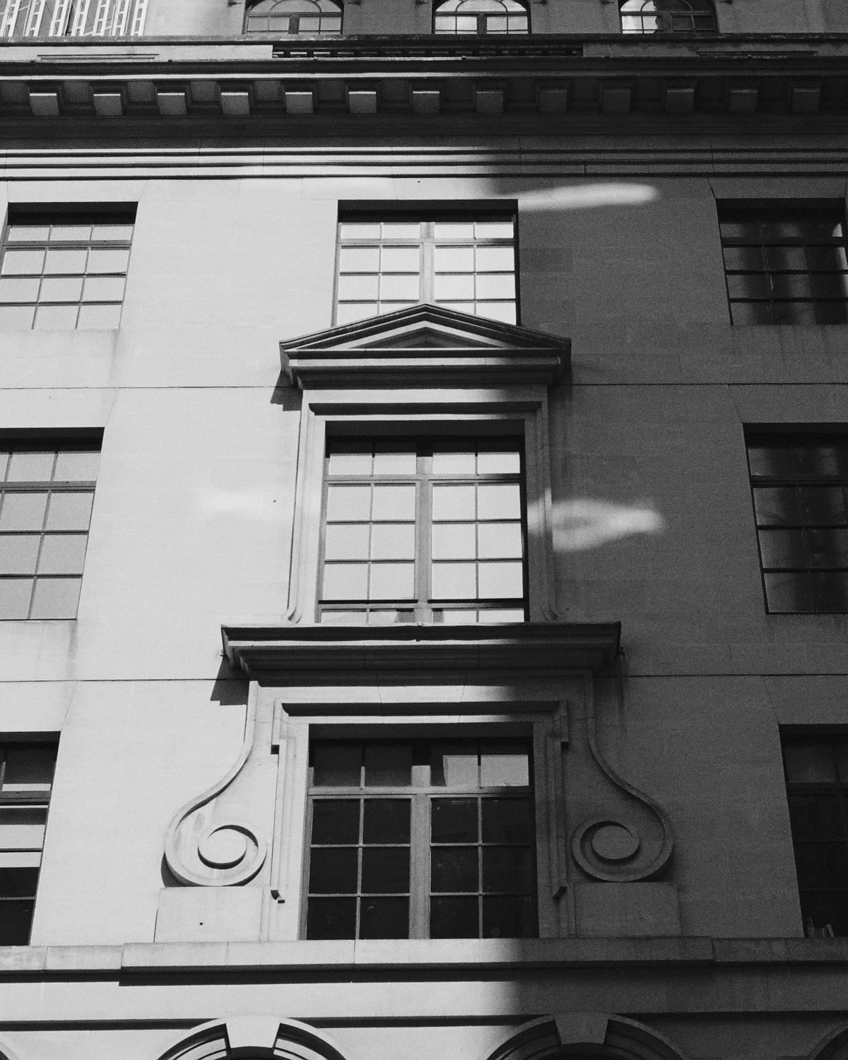 Stone facade and sash windows in afternoon light